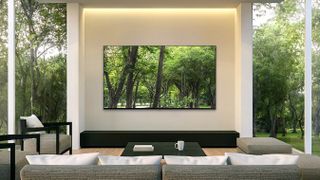 A Samsung Q85 QLED TV wall-mounted in a nice home theater setup