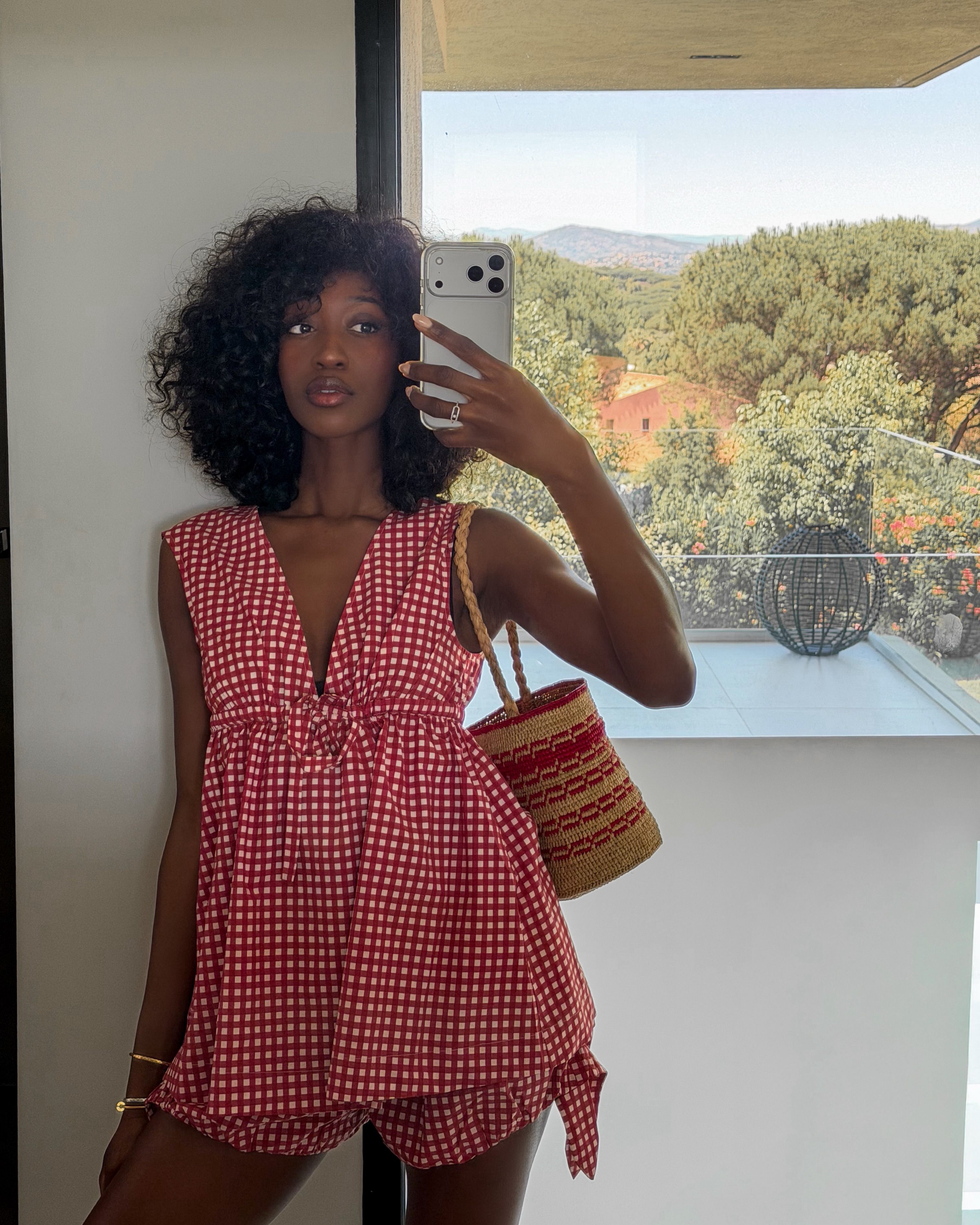 Emmanuelle wearing red gingham set and woven bucket bag