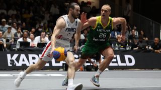 France's Hugo Suhard and Lithuania's Evaldas Dziaugys in a FIBA qualifying match for the 2024 Summer Olympics.