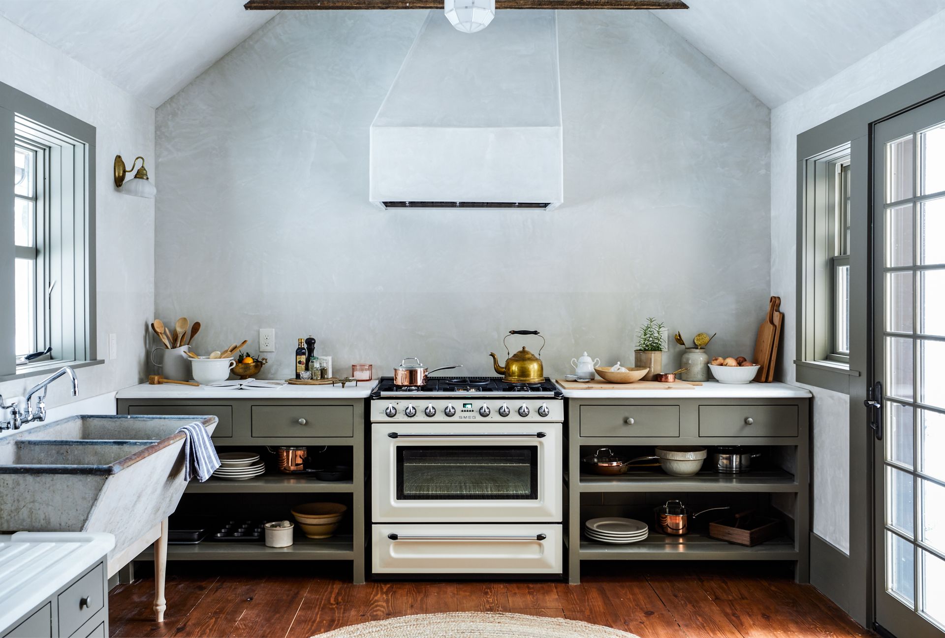 kitchen with grey plaster walls and grey cabinets