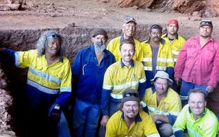 An image of a group of men in an archaeology excavation site