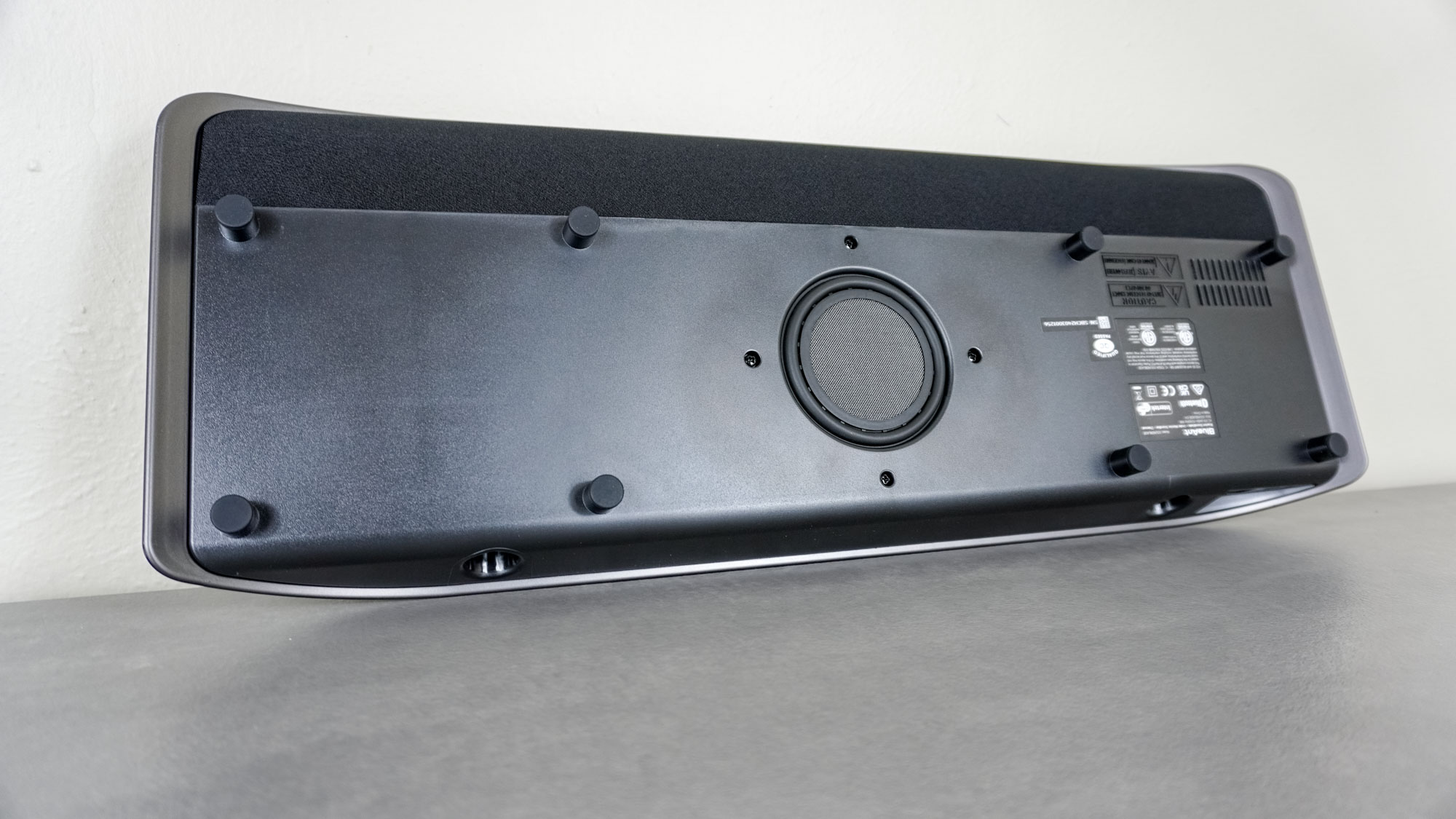 The underside of the BlueAnt Soundblade showing its subwoofer and rubber feet
