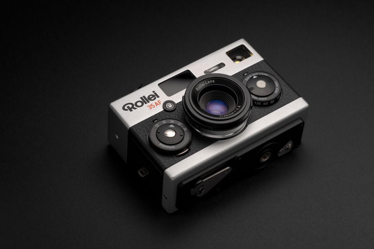 Rollei 35AF film camera on a gray surface and black background