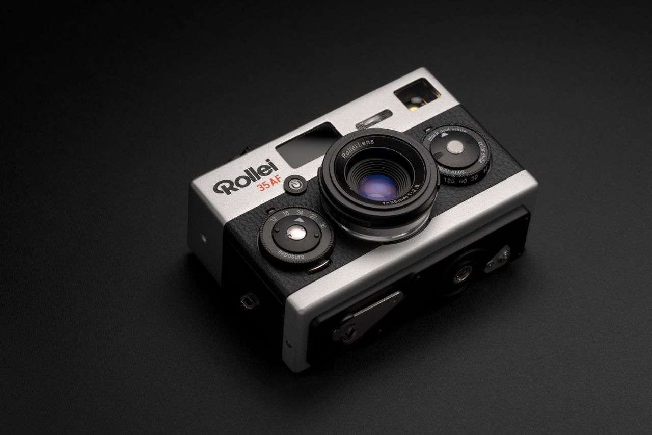 Rollei 35AF film camera on a gray surface and black background