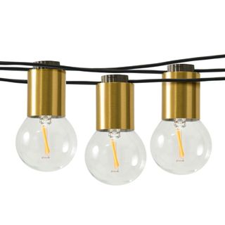 Three black wires holding up three brushed gold festoon lights with clear glass bulbs