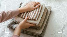 picture of woman folding clean laundry 