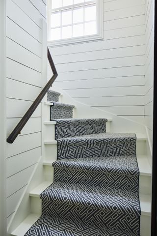 A staircase with white horizontal panels