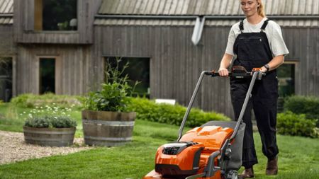 Woman mowing lawn with Husqvarna lawn mower