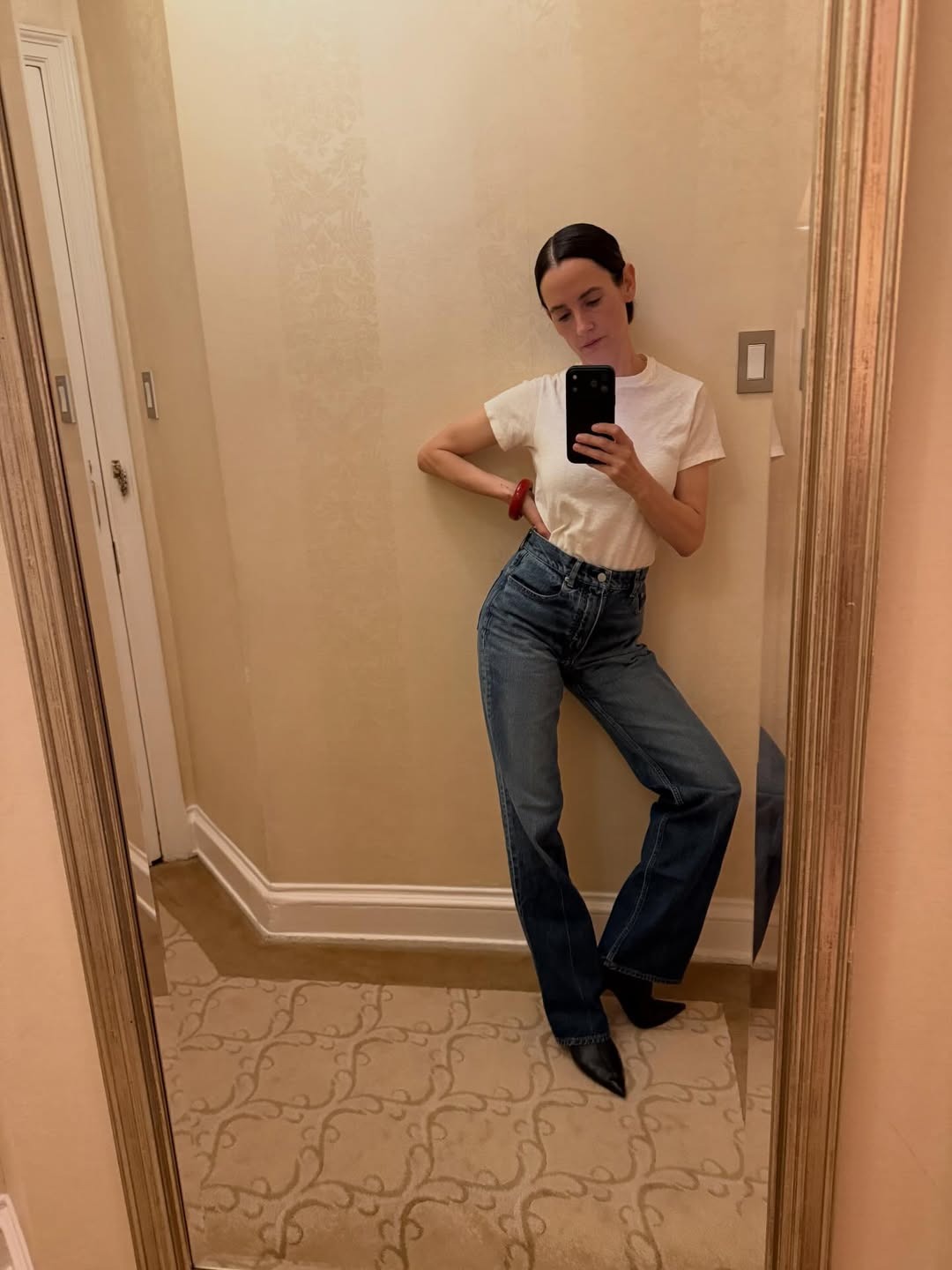 Karla Welch wearing a high-rise bootcut jeans outfit.