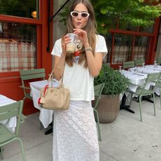 Woman in graphic t-shirt and lace skirt