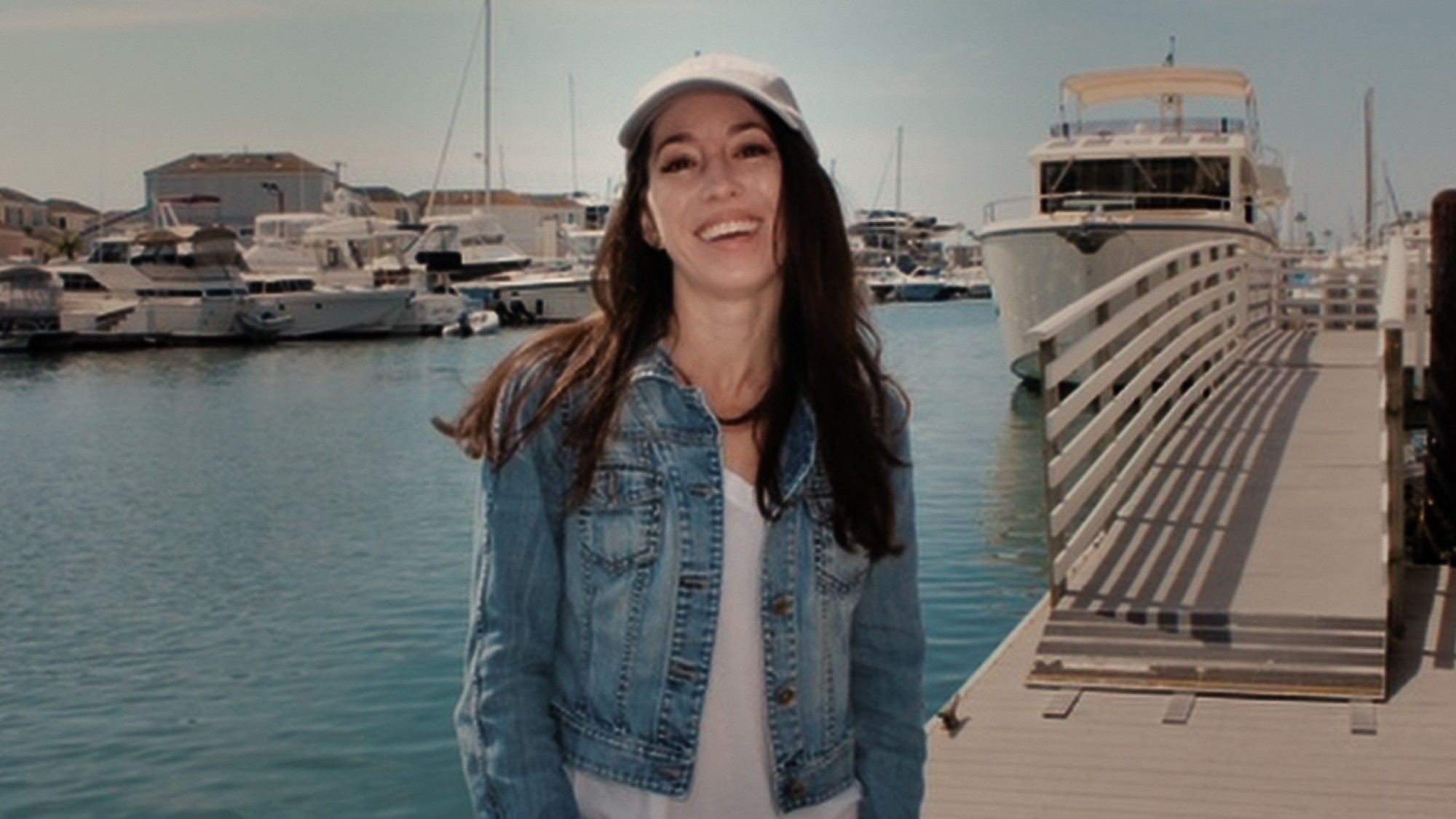 MIchelle standing and smiling on a dock