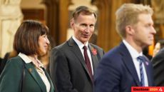 Chancellor Jeremy Hunt and shadow chancellor Rachel Reeves walking through the Houses of Parliament. 