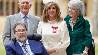 Kate Garraway, with her husband Derek Draper and her parents Gordon and Marilyn Garraway, after being made a Member of the Order of the British Empire for her services to broadcasting, journalism and charity by the Prince of Wales during an investiture ceremony at Windsor Castle, on June 28, 2023 in Windsor, England.