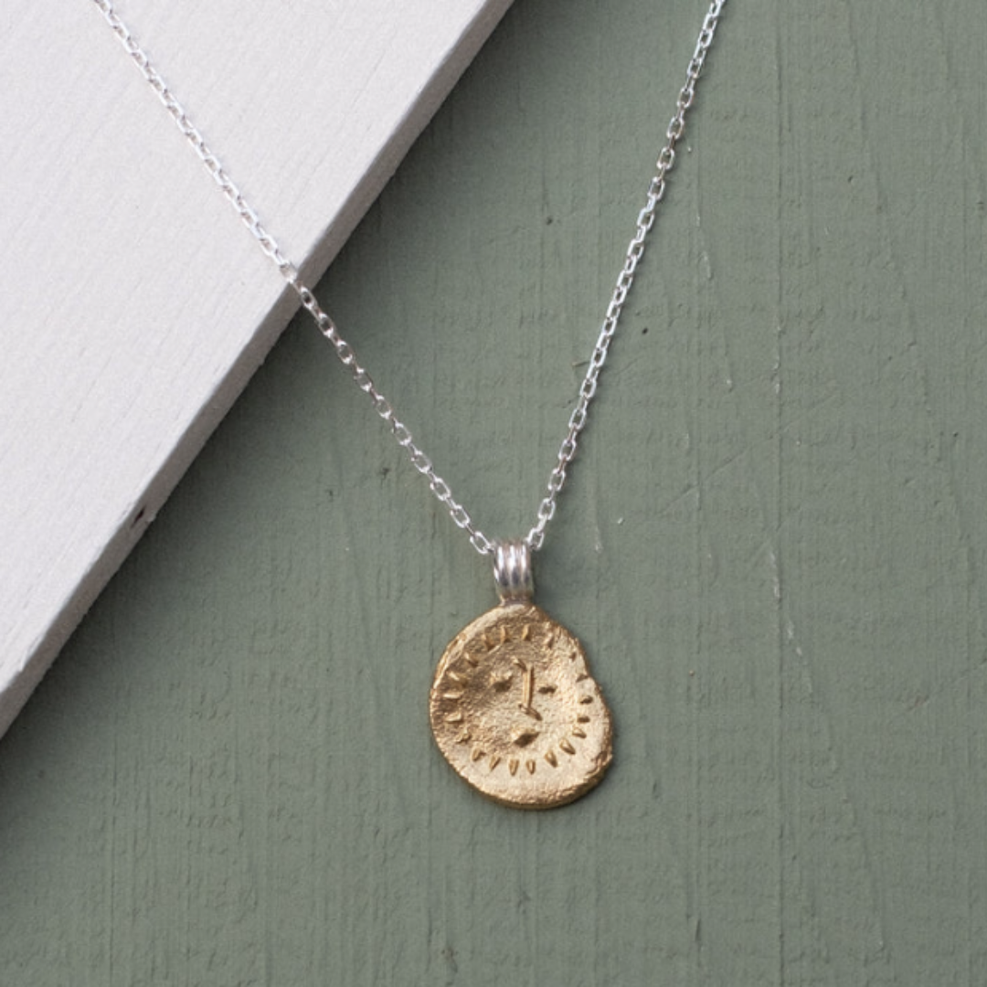 ethical jewellery brands: gold and silver necklace with sun detail