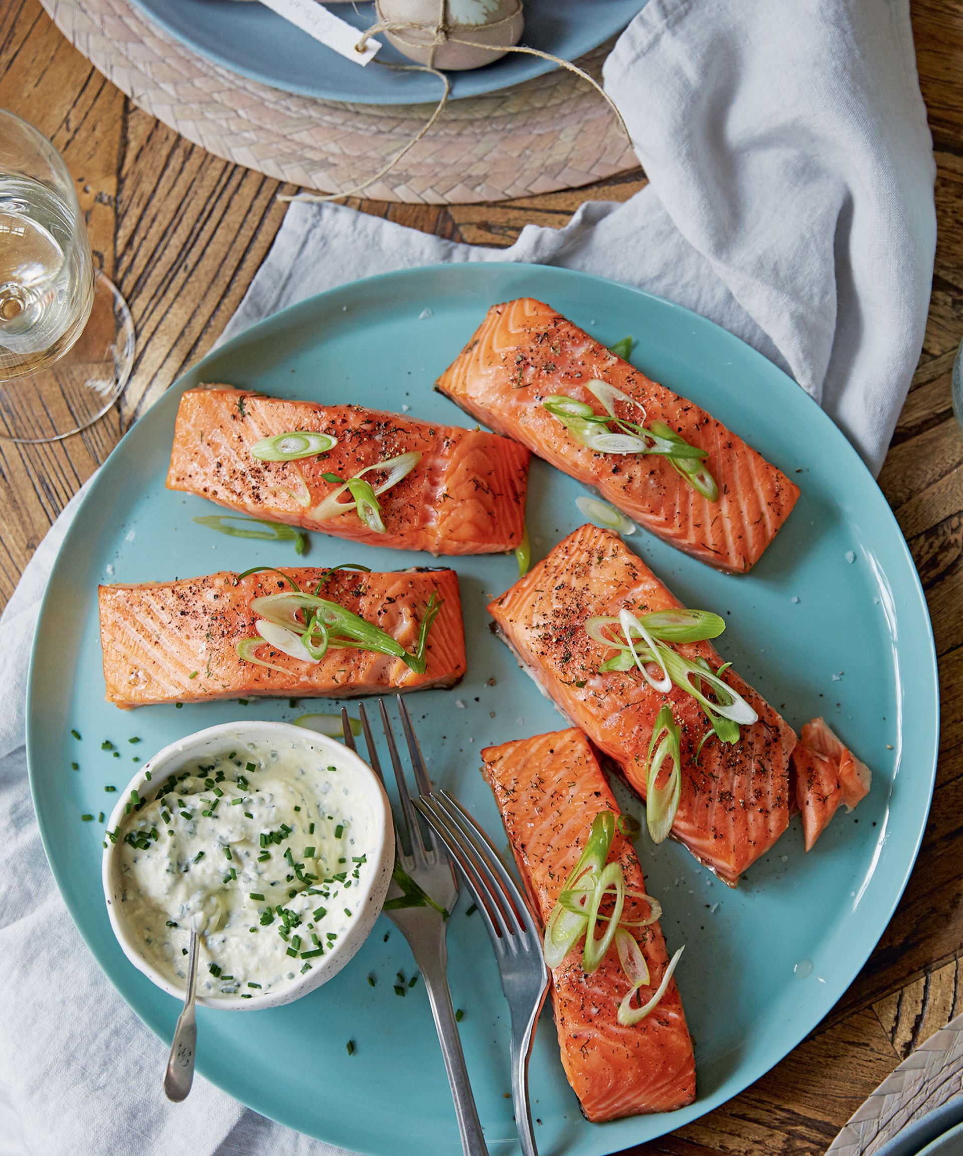 Overhead image of a salmon recipe on a blue plate