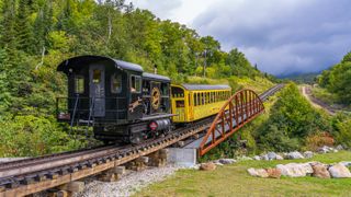 Climbing train on rack railway takes tourists to the top of Mount Washington