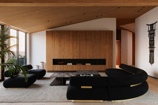 panelled living room with large black sofa