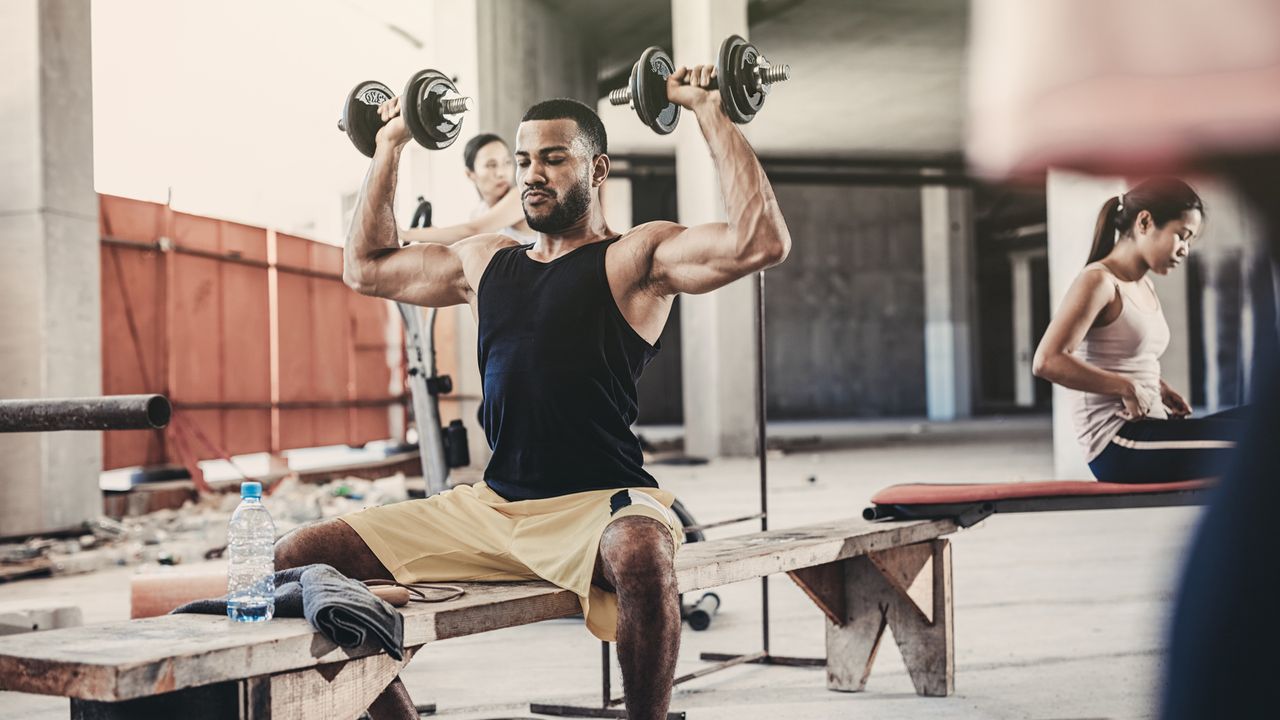 Man performing a dumbbell Arnold press