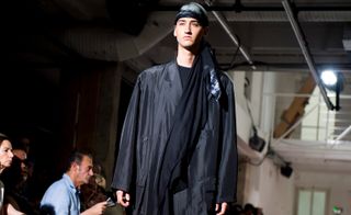 Male model wearing black Yohji Yamamoto outfit at Paris fashion week 2018