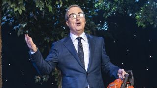 John Oliver with a chainsaw in Last Week Tonight