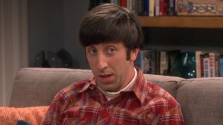 Howard reading book on couch on The Big Bang Theory