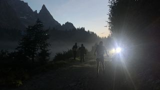 Runners in the UTMB at dawn wearing headlamps