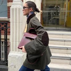 Woman wears green jacket with patch elbow