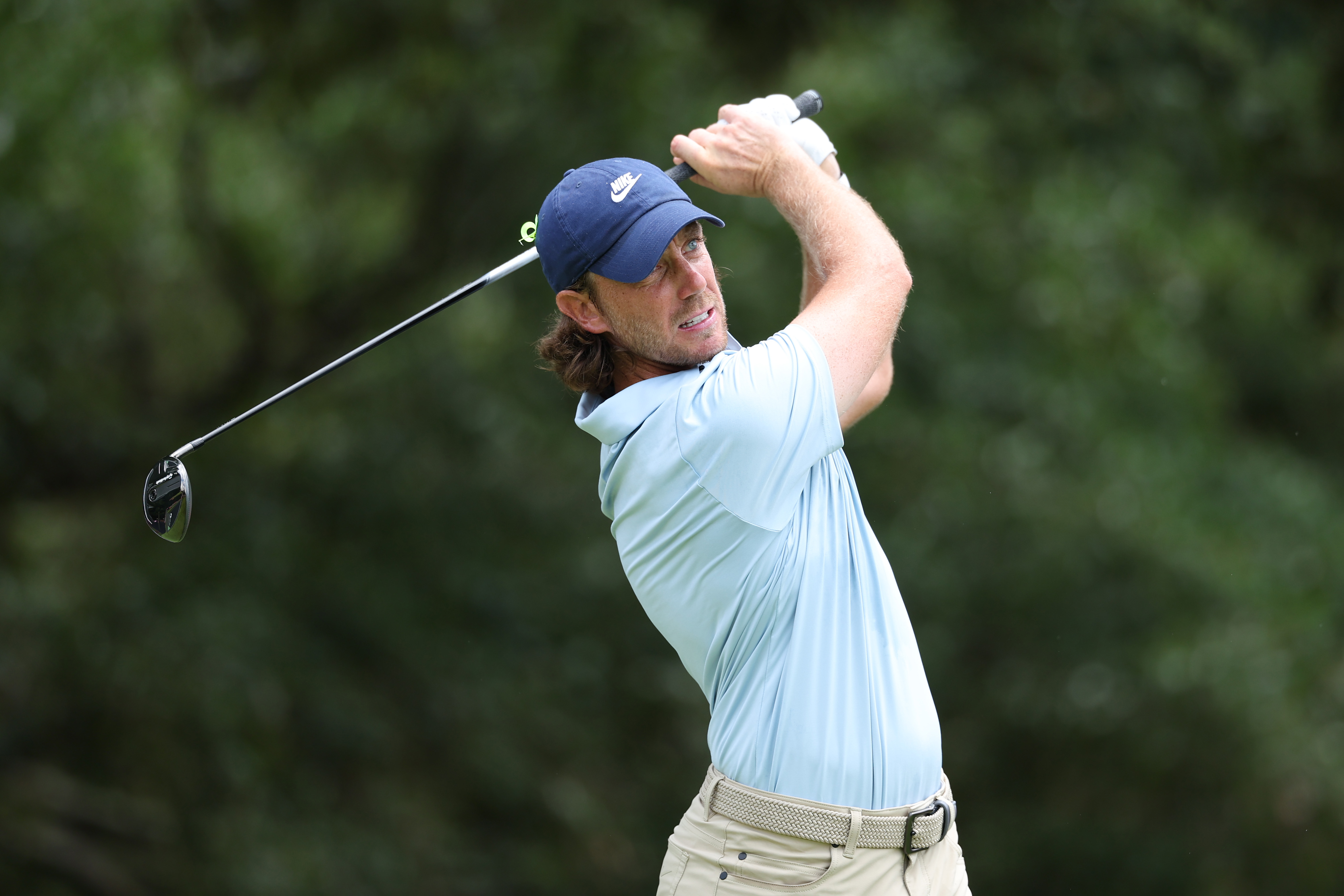 Tommy Fleetwood hits a fairway wood