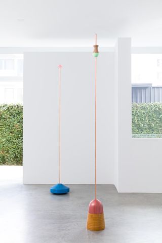 Blue and pink floor sculptures with antennas