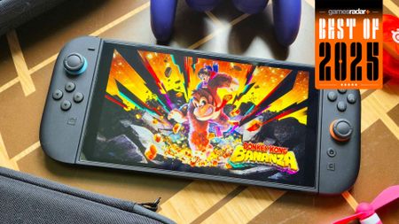 The Nintendo Switch 2 playing Donkey Kong: Bananza and surrounded by accessories on a wooden table