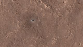NASA's InSight lander is covered in dust in this March 9, 2022 image acquired by the High Resolution Science Experiment (MRO) aboard the Mars Reconnaissance Orbiter spacecraft.