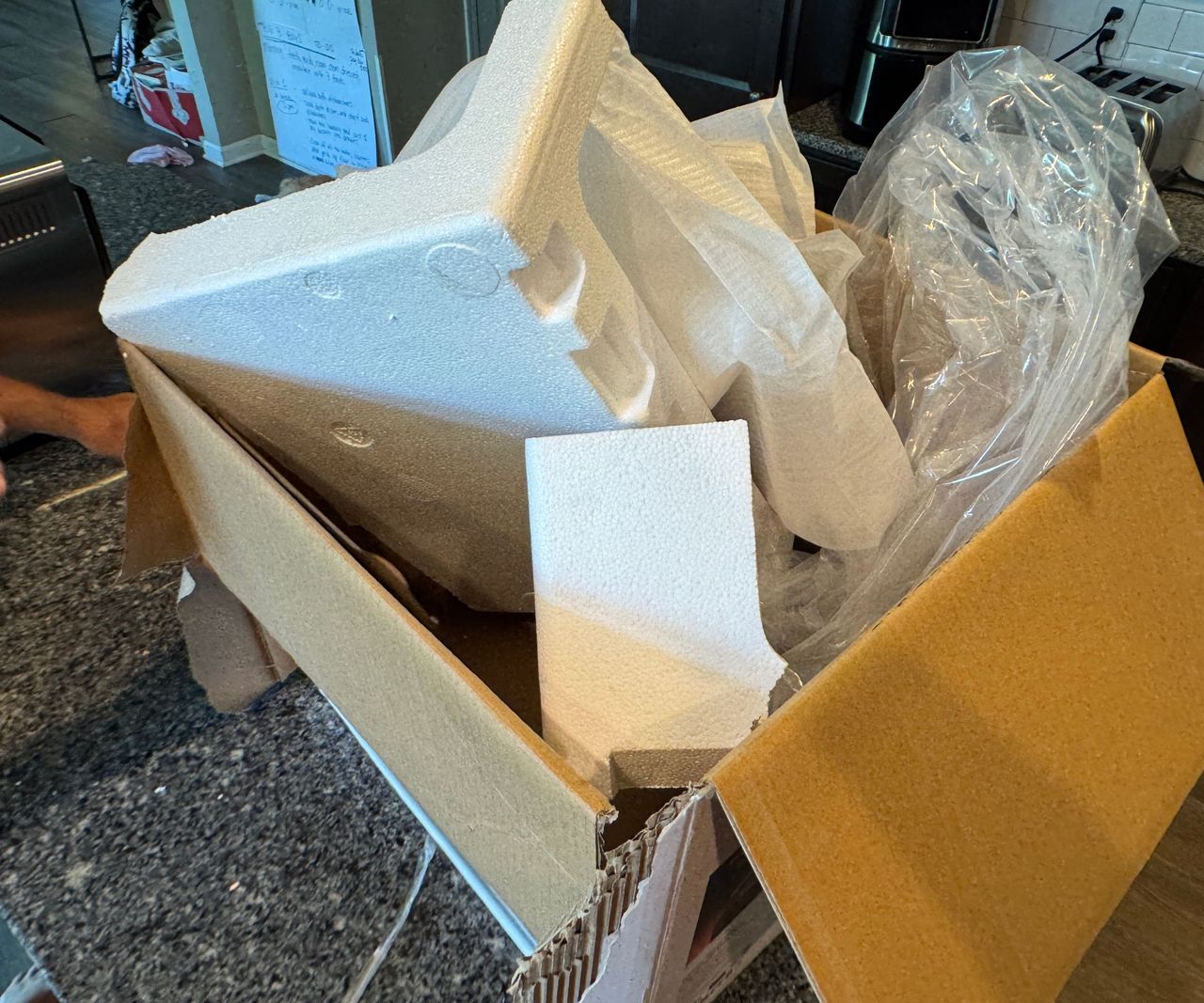 The polystyrene packaging for the typhur sync in a brown cardboard box.