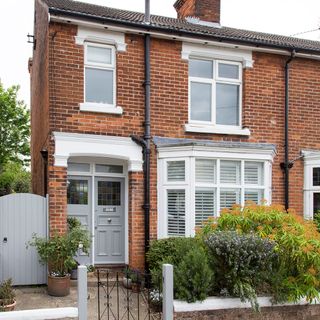 house with brick wall and white window