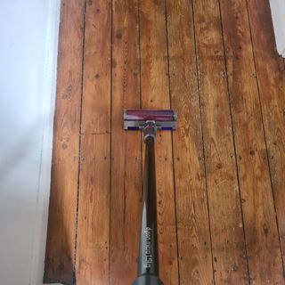 Dyson Micro 1.5kg being used on a wooden floor