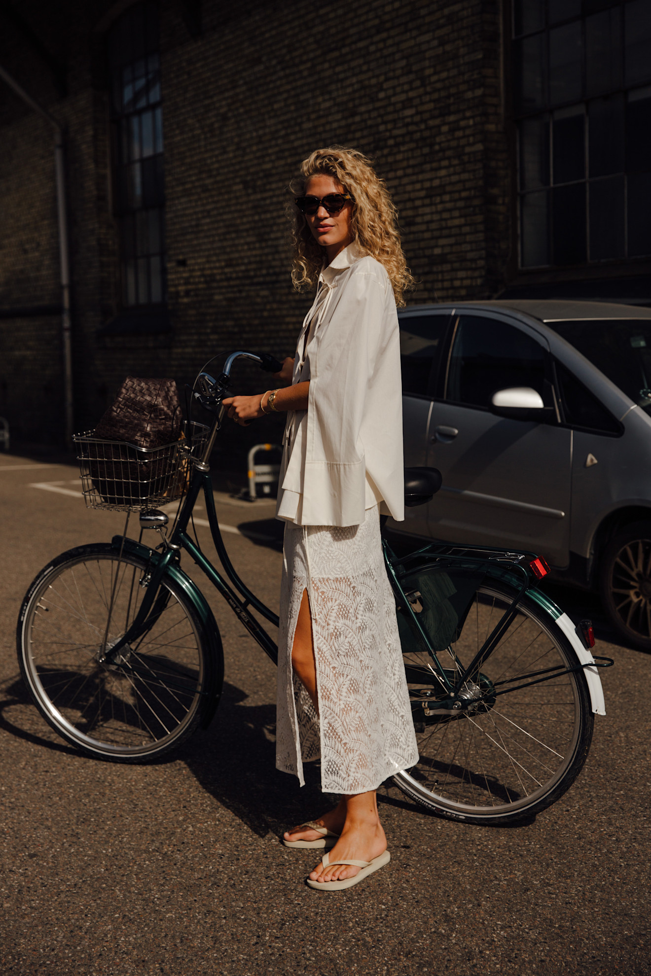 woman wearing sheer trend, blazer, and flip-flops