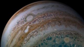 Two white, oval-shaped storms in Jupiter's atmosphere are now merging into one. NASA's Juno spacecraft caught these anticyclonic storms in the act using its JunoCam imager on Dec. 26, 2019, as the spacecraft was completing its 24th perijove, or close flyby of the planet. At the time, Juno was passing about 44,900 miles (72,200 kilometers) above Jupiter's cloud tops at a latitude of about 60 degrees south. NASA has been tracking the larger of the two merging storms for years, and scientists have watched it gobble up several smaller storms in the past, NASA said in a statement. It narrowly avoided a merger with this same storm just a few months before this image was captured, when the two made a close approach as they churned through the planet's turbulent atmosphere.