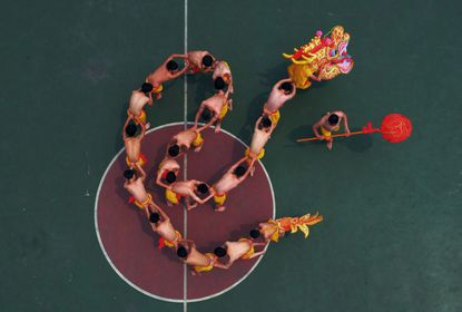 Students learn to perform a dragon dance.