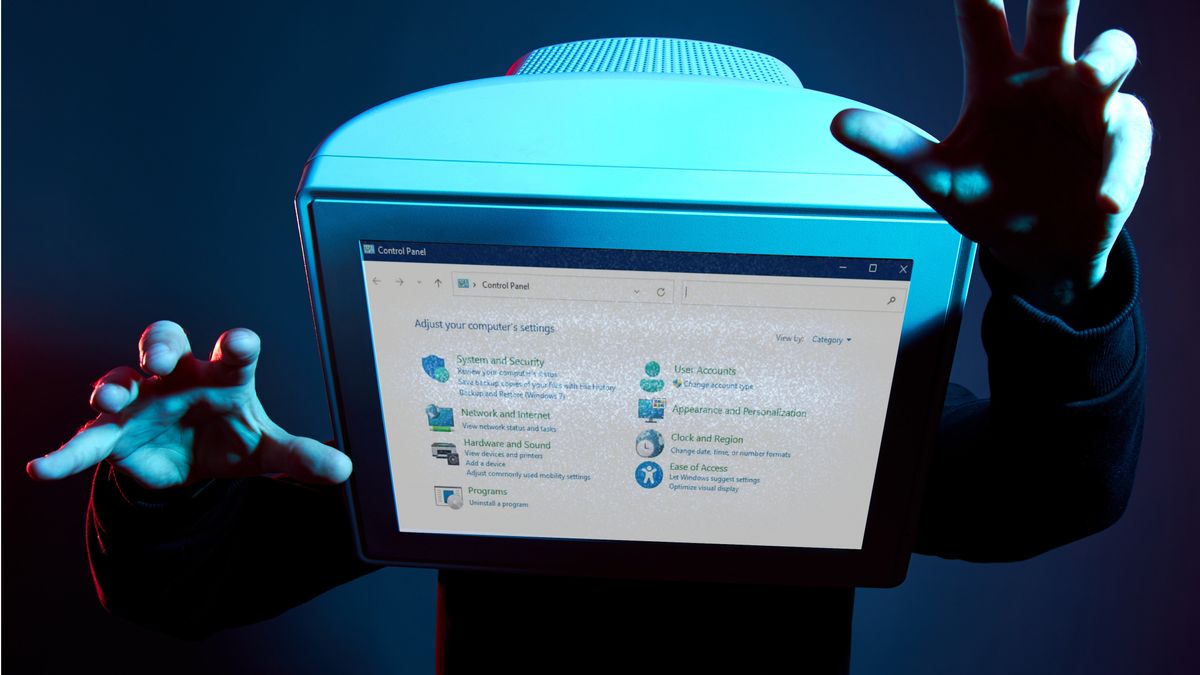 Man with a CRT monitor showing the Windows 11 control panel for a head
