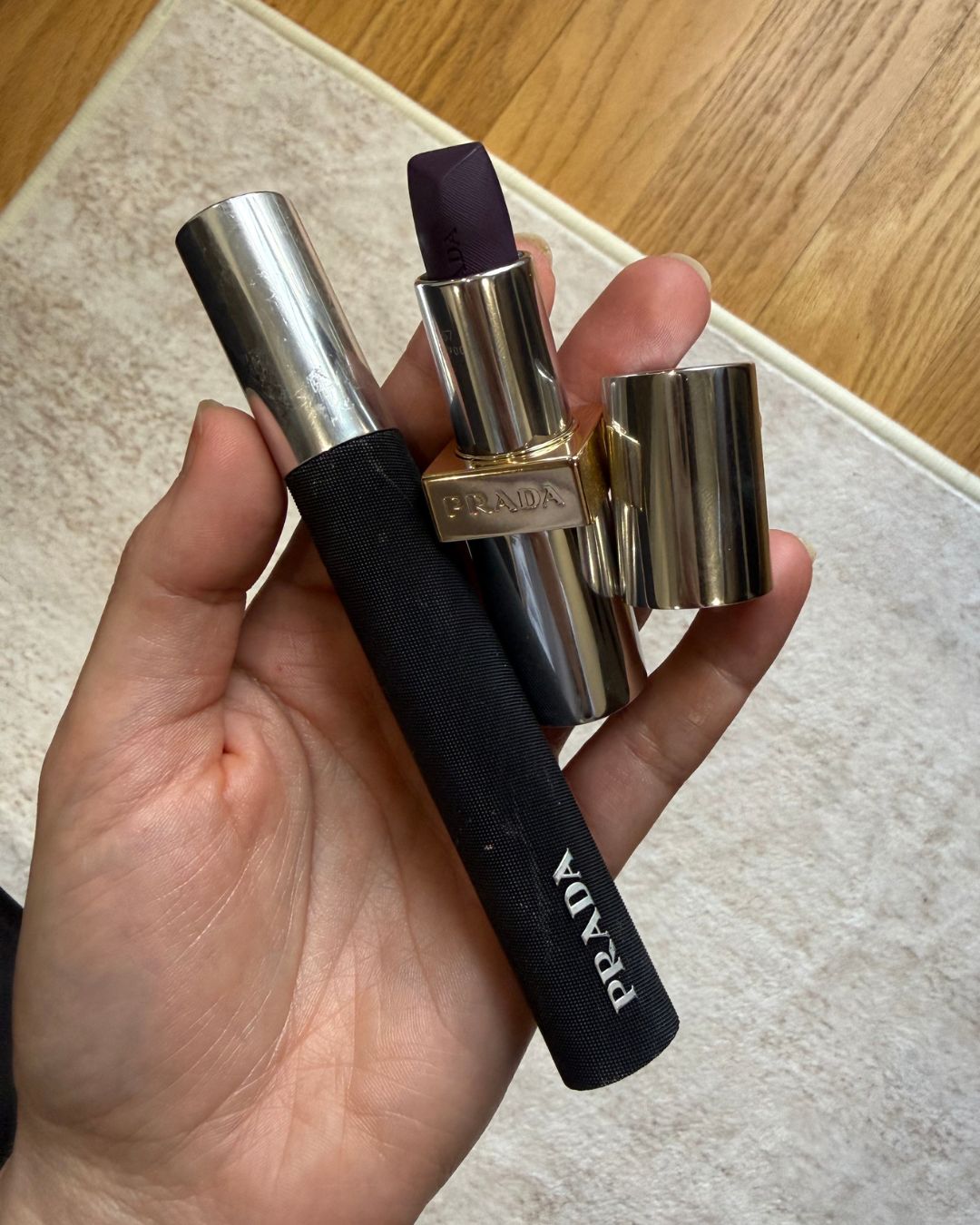 An image of WWW senior beauty editor Jamie Schneider wearing and holding Prada Beauty products.