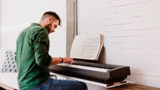 Man playing Yamaha digital piano 