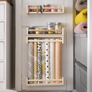 Ikea spice racks used to store craft essentials on the back of a cupboard door
