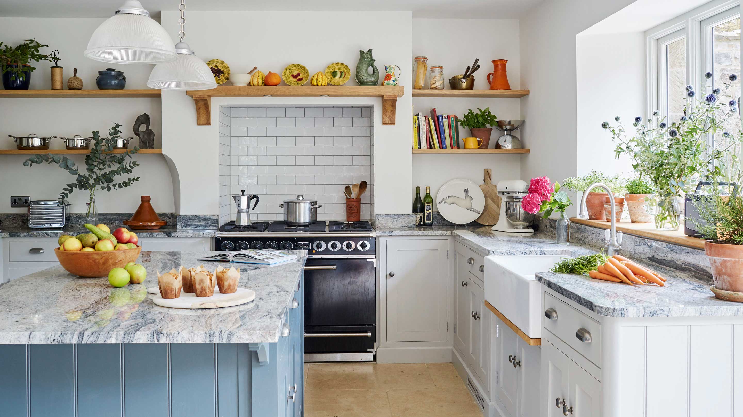 Kitchen in a renovated home with kitchen island and stone worktops