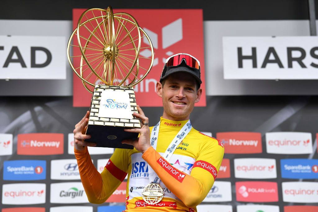 HARSTAD NORWAY AUGUST 08 Ben Hermans of Belgium and Team Israel StartUp Nation Yellow Leader Jersey celebrates at podium as race winner during the 8th Arctic Race Of Norway 2021 Stage 4 a 1635km stage from Gratangen to Harstad 54m ArcticRace on August 08 2021 in Harstad Norway Photo by Stuart FranklinGetty Images