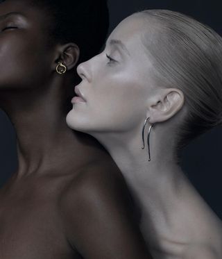 Two girls are wearing earrings