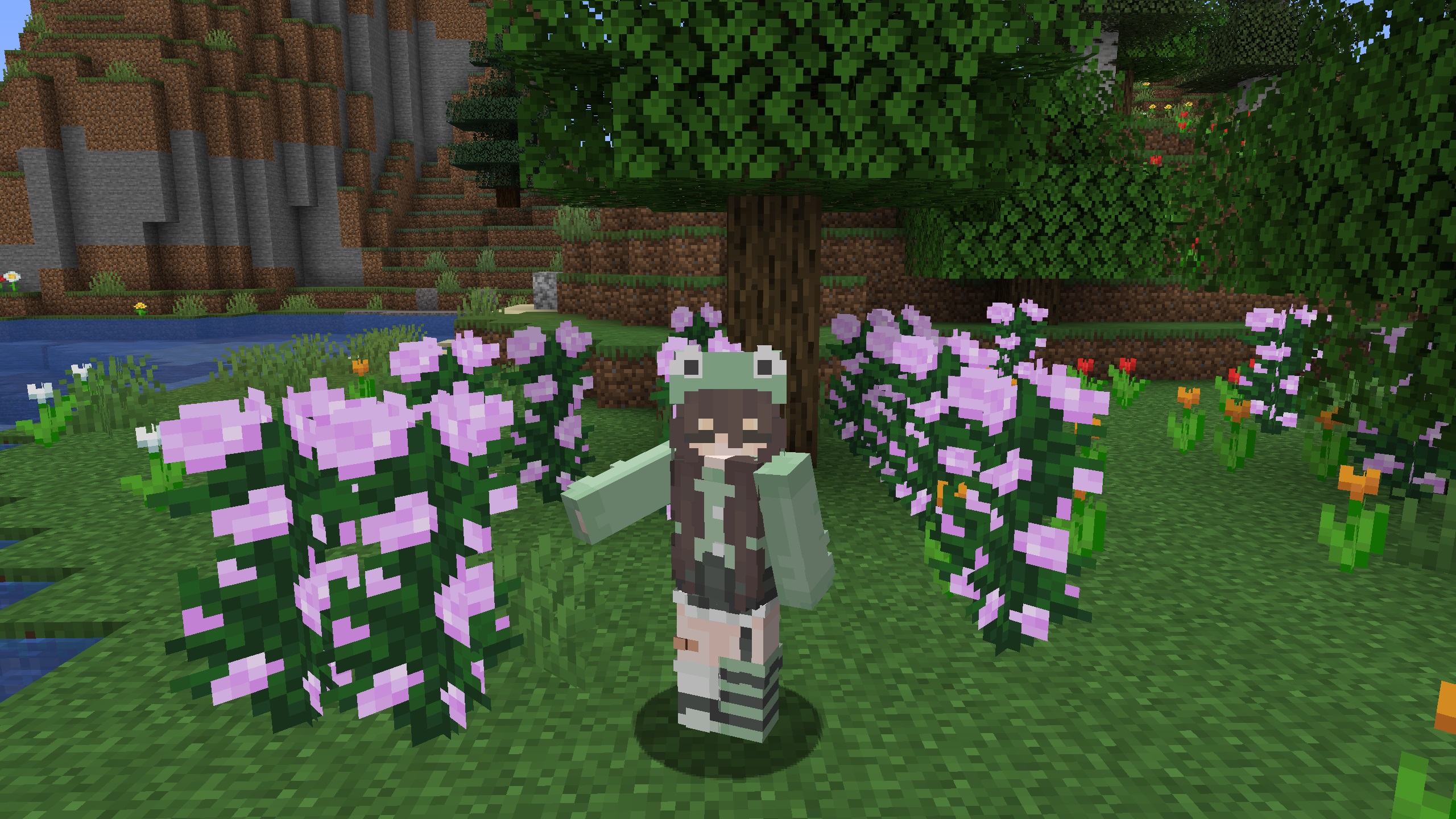 Minecraft skin - A girl with brown hair wearing a green hoodie that has frog eyes and shorts with sneakers.
