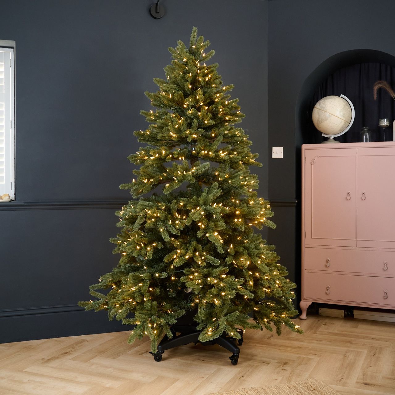 Balsam Hill's Vermont White Spruce Flip Tree in a black-painted living room