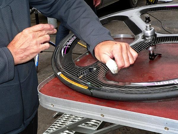 T-Mobile mechanics hand-applied a line of silicone adhesive to fill the wind-churning trough in between the tire and rim.