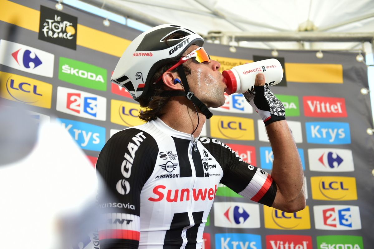 Michael Matthews takes in a quick sip of water before the TV interview as stage winner