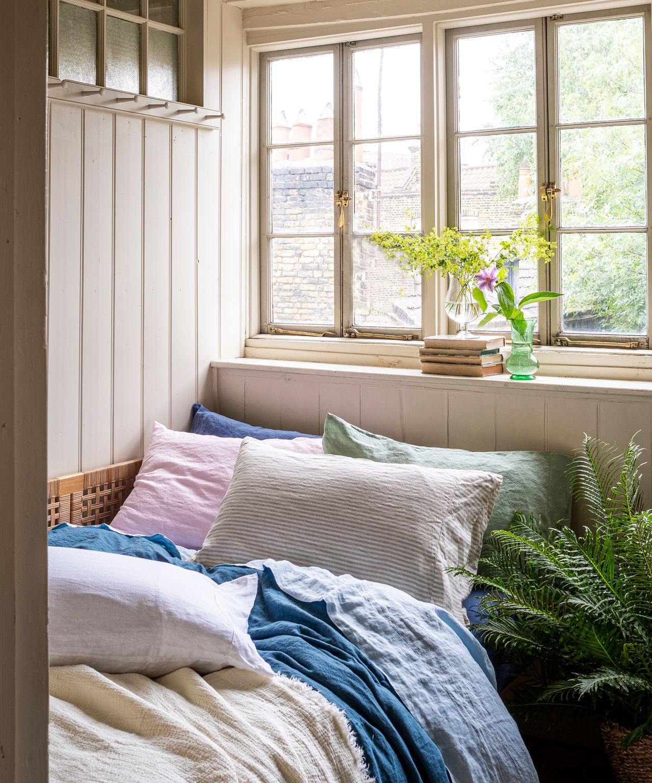 modern pastoral bedroom with pastel bedlinen and fresh plants