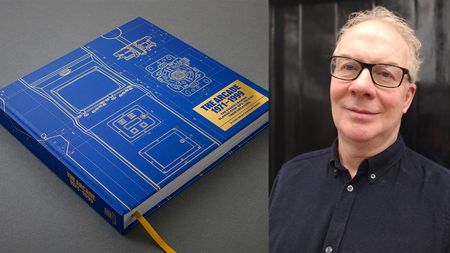 A blue book and a man in a blue short and glasses